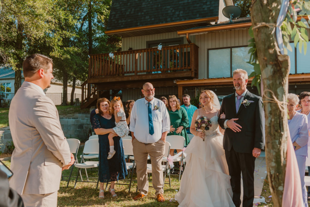 This couple chose to see each other walking down the aisle instead of a first look- bride walking with her dad.